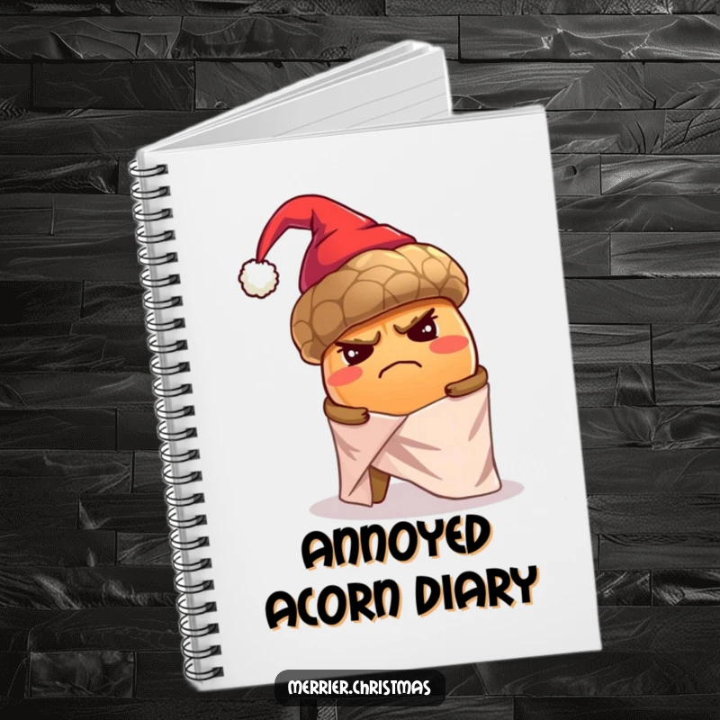 Funny notebook cover with a grumpy, oversized acorn in a tiny Santa hat struggling to wrap itself alone in shiny holiday paper.